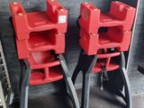 two red high chairs that are next to each other