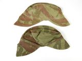 pair of military hats with camouflage print on them on a white surface