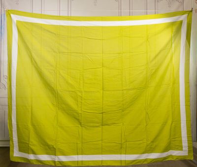 an image of a yellow and white quilt hanging on a wall