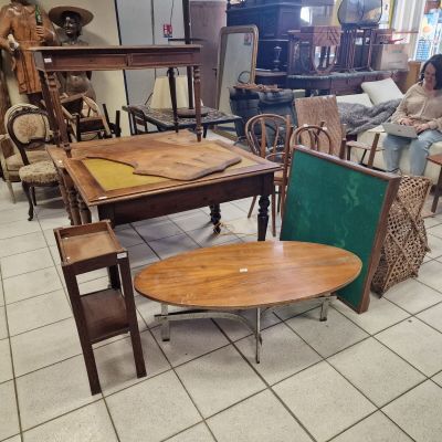 a woman sitting at a table in a room full of furniture
