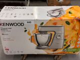 a box of kenwood mixer on a cart in a store