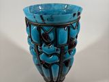 a blue vase with a black design on it