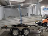 a trailer with a cage on the back of it in a garage