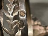a close up of a metal object with a flower on it