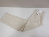 a pair of pants on a table with a price tag on it