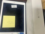 an apple ipad is sitting on a table next to a box with a sticky note on it