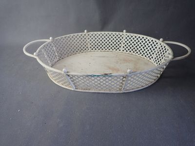 an old white metal basket with handles and handles on a black background