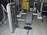 a gym equipment set up in a room with a yellow wall