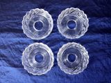 four clear glass bowls on a blue cloth with a blue background