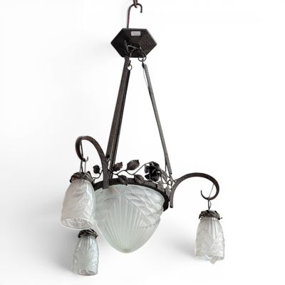 an image of a chandelier with three glass shades hanging from the ceiling