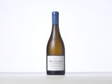 a bottle of white wine sitting on top of a table