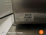 a close up of a stainless steel microwave on a counter