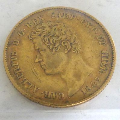 an old gold coin with a woman ' s head on it