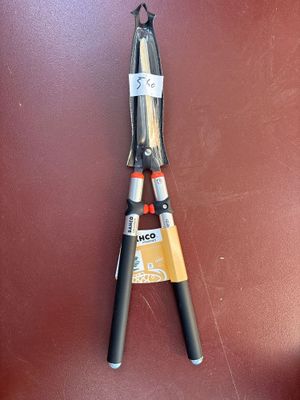 a pair of scissors hanging on a brown wall