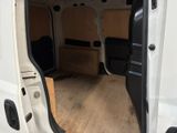 a white van with the door open on a wooden floor
