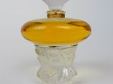 yellow glass perfume bottle with a white top and a gold cap