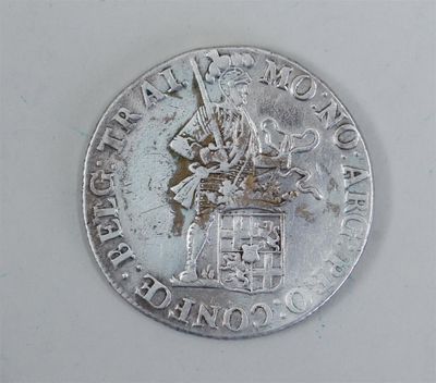 a silver coin with a picture of a man riding a horse