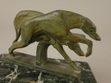 statue of a running greyhound on a marble base