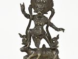 a bronze statue of a woman with a bird on her head