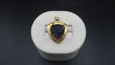 a close up of a ring with a blue stone in it