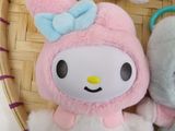 two stuffed animals sitting in a basket on a table