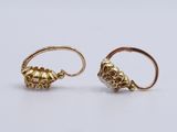 a pair of gold - plated earrings with pearls