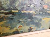 a painting that is on the wall by the window
