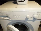 a white washer and a dryer sitting on top of each other