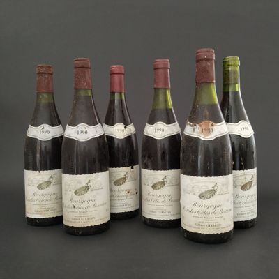 several bottles of wine are lined up on a table
