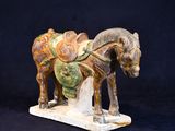 a statue of a horse with a saddle on it ' s back