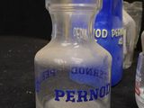 three glass jars that are sitting next to each other