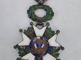a close up of a medal on a white surface with a red ribbon
