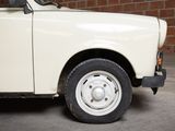 a small white truck parked in front of a brick wall