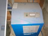 a blue machine that is sitting in the corner of a room