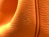 a close up of a bag with a small spot on it