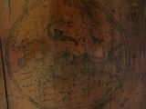 a wooden cabinet with a map on it
