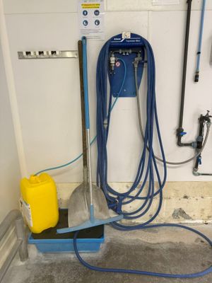 a blue hose and a yellow can on the floor