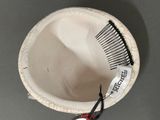a white bowl with a black comb and a pair of scissors