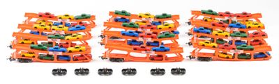 several toy cars are stacked on top of each other on a white surface