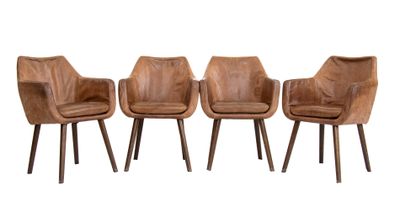 three brown leather chairs sitting next to each other on a white surface