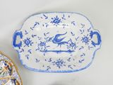 a blue and white platter with a bird on it