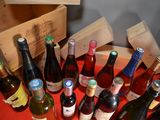 many bottles of wine sitting on a table with a red cloth