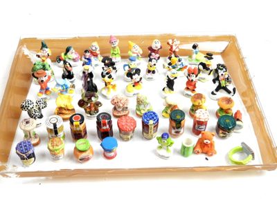 many small figurines in a box on the table