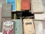 many old books stacked on top of each other on a table