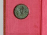 an old book with a coin in it sitting on a table