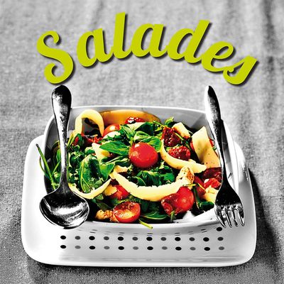a plate of salad with a fork and knife on it