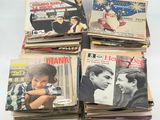 several magazines are stacked on top of each other on a table
