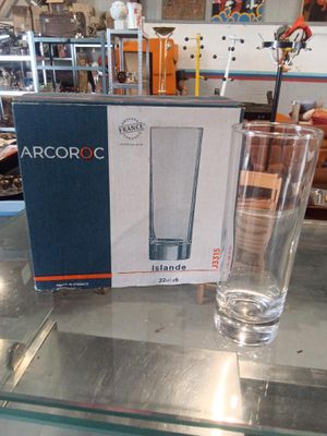 a glass of water sitting on a table next to a box