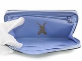 someone is holding a blue wallet with a rabbit on it