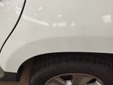 a close up of a white car with a black stripe on the side of it